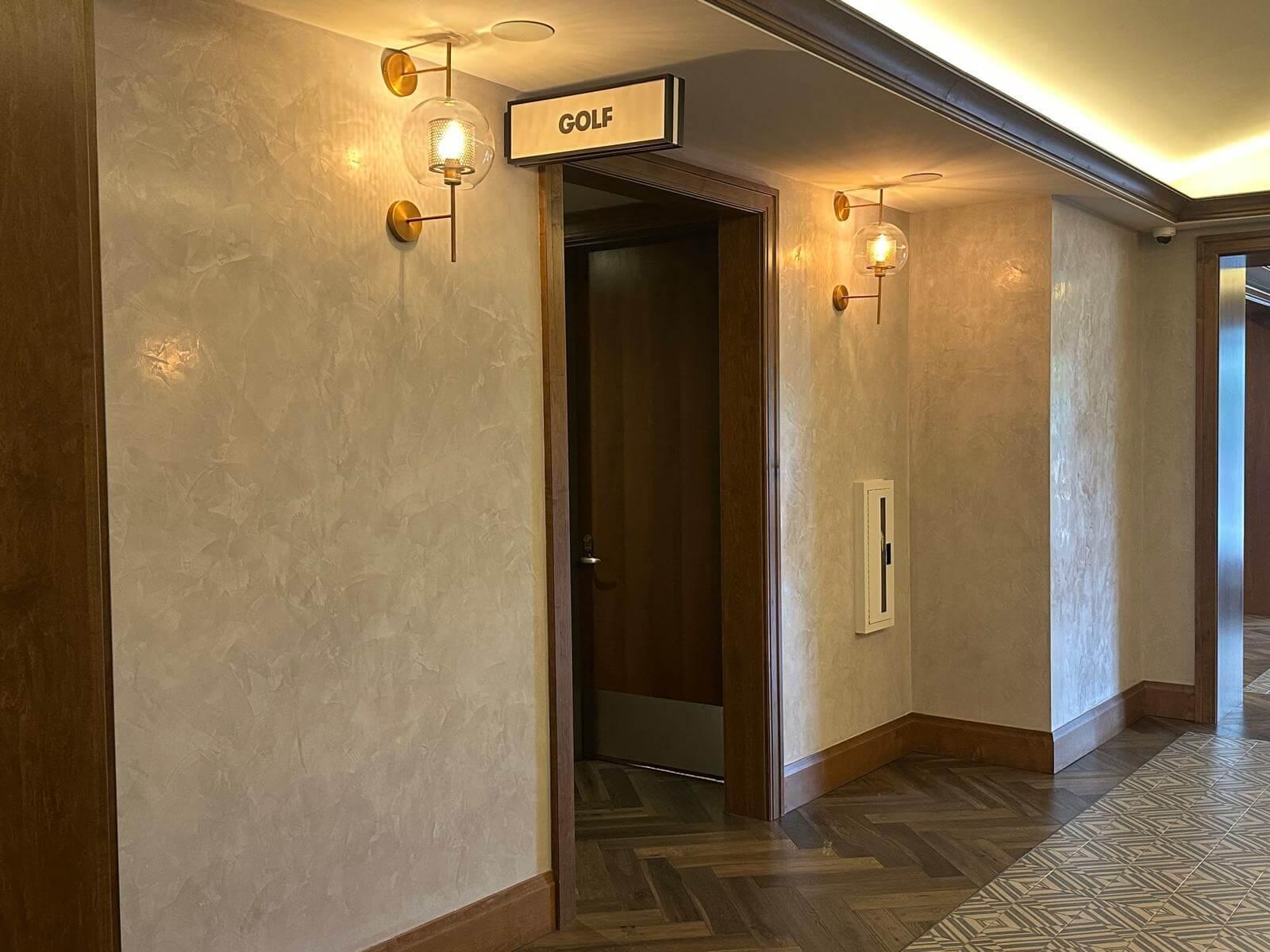 Lobby with vintage lamps neutral beige wash wallpaper.